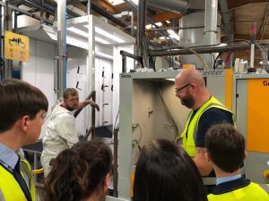 students on a factory tour watching sheet metal fabrication